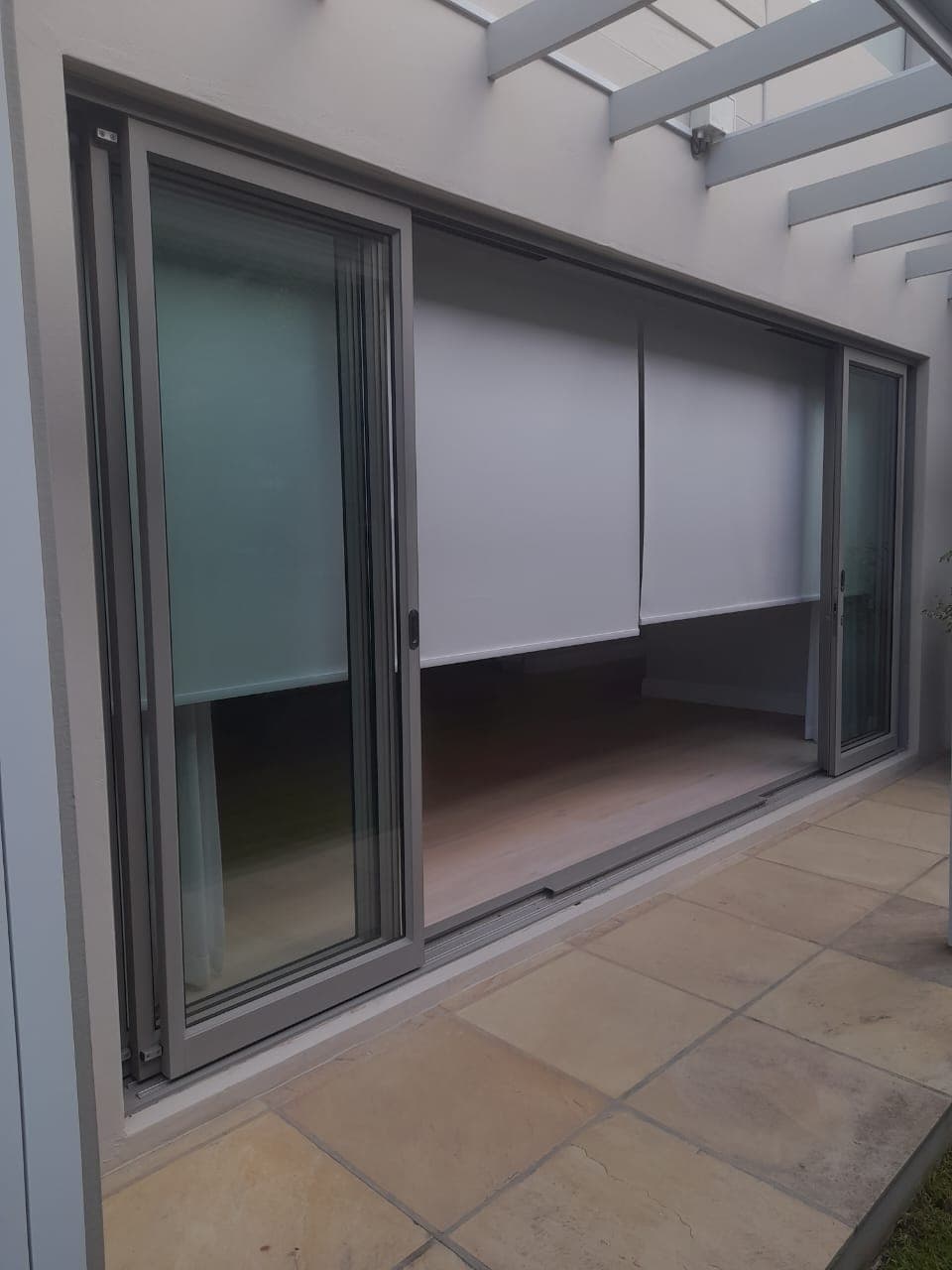 Aluminium sliding door installed onto a paved patio